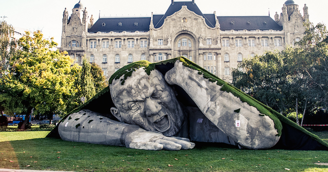 The sculpture, whose title translates to "popped up," seems to emerge in front of some of Budapest's historical buildings.