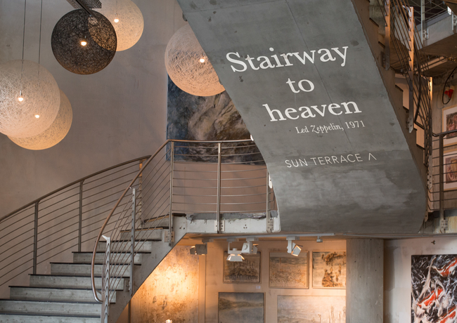 The stairway in the hotel's art gallery, which leads to a sunny terrace.