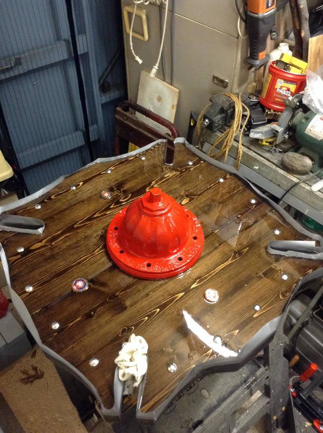 He poured epoxy on the table to finish the surface.