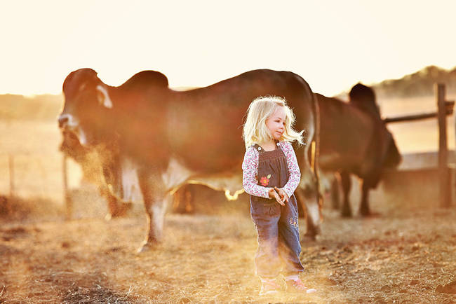 She clearly feels right at home among the massive animals.