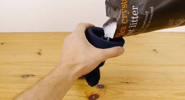 Fill a sock with cat litter. Then wrap that sock in another sock and tie it up tight.