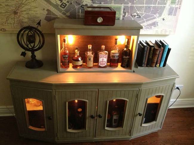 The cabinet has a hidden liquor cabinet inside of it that lifts up for easy access.