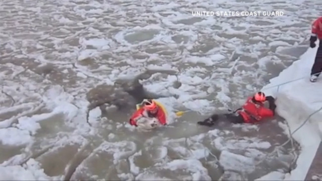 Boatswain mate third class Tim Putnam swam over 650 feet into the lake, pushing his way through icy slush and past big blocks of ice.