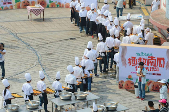 The cooks formed an assembly line to add the ingredients.