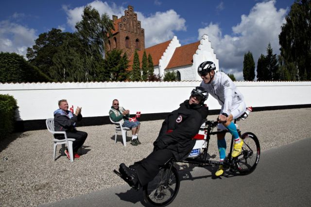 Together, they ride a specially-made bicycle that can accommodate two riders.