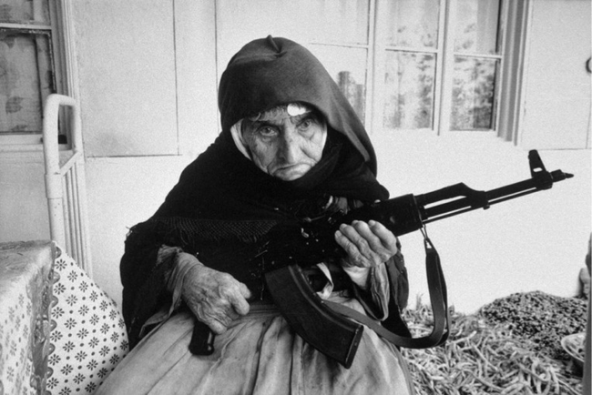 9.) 106-year-old Armenian woman protecting her home in 1990.