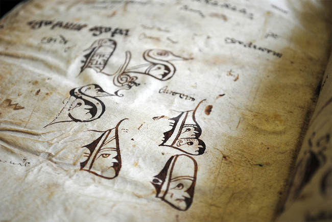 Faces in letters. A scribe possibly made these when warming up before the production of a manuscript. They had to be precise; there were no erasers!