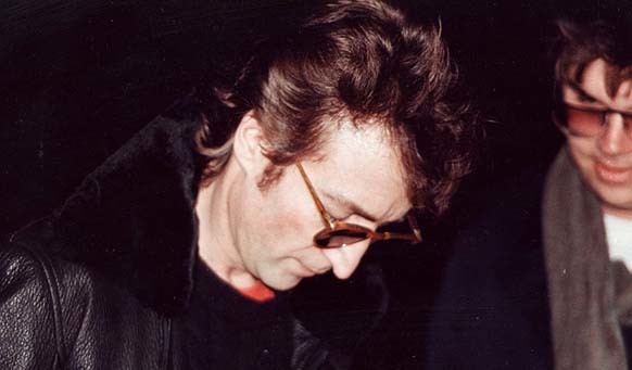 10.) The man who shot John Lennon, Mark David Chapman, appeared in the last photo taken of the musician. He was asking for an autograph.