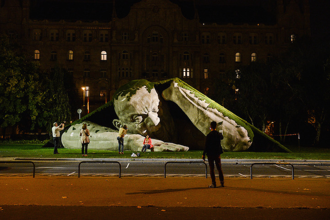 Visitors interact and pose with the sculpture, which the artist encourages.