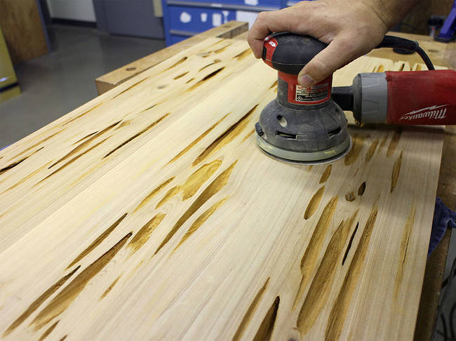 After cutting the board to the proper specifications, the next step was to begin sanding down the wood to give it a smooth feel.