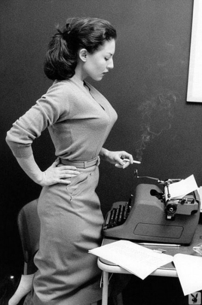 Girl with typewriter and a smoke.