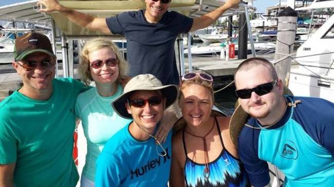 First, Brad went swimming with sharks. Here he is with his family getting ready for the swim.