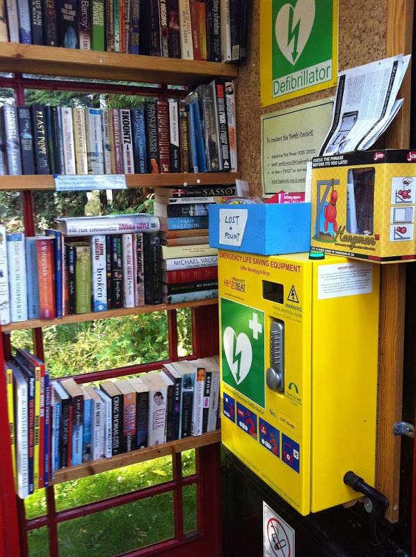 This box does double duty as a library and emergency defibrillator site. (Also there's a lost-and-found.)