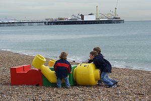 Children play with the figure that appeared on Brighton Beach in the U.K.