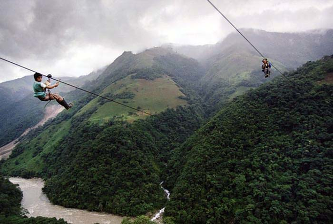 9.) Above The Rio Negro River, Colombia - Kids zip line across the river to get to school.