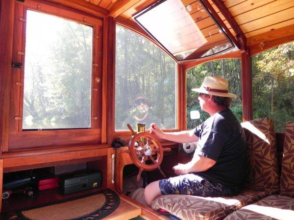 The steering column is an old-fashioned wooden wheel with spokes that hearken back to the days of tall ships.