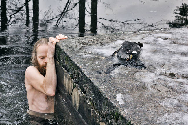 He was already in his swim trunks and ready to plunge when he saw the distressed duck.