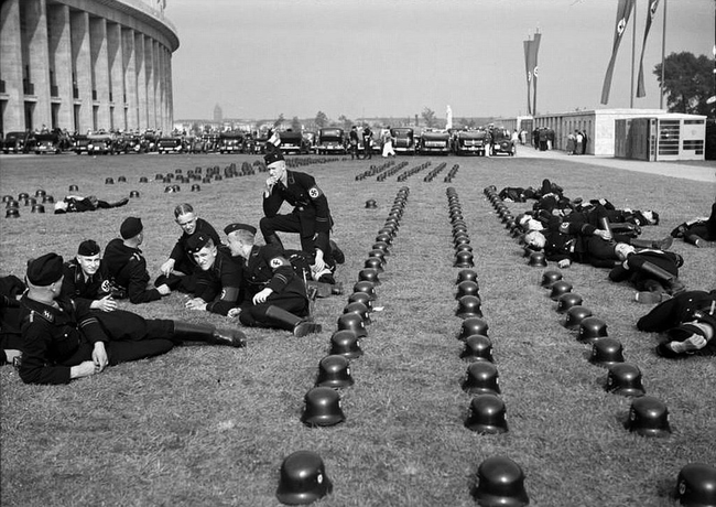 5.) Nazi SS troops lounging outside of the Olympic Games in Berlin in 1936.