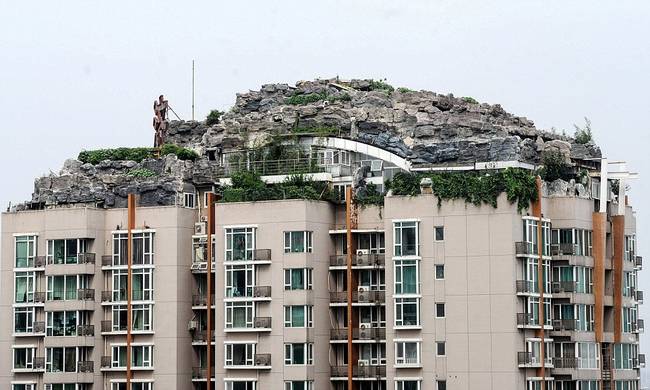 Lin has spent the last 6 years building his mountain home on top of this apartment complex.