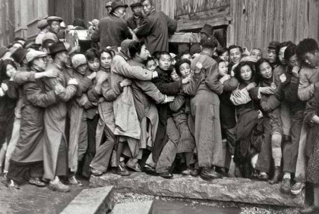 16.) A rush on the banks to withdraw gold before the arrival of the communists in Shanghai, China, 1949.