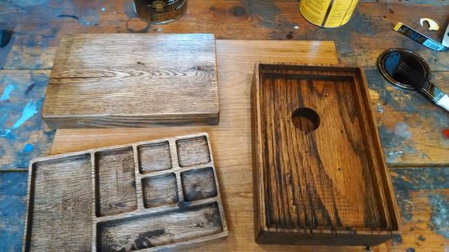 Different parts of the box were cut, sanded, and stained to give them a well-worn look. He then installed the intricate machinery inside of the box.