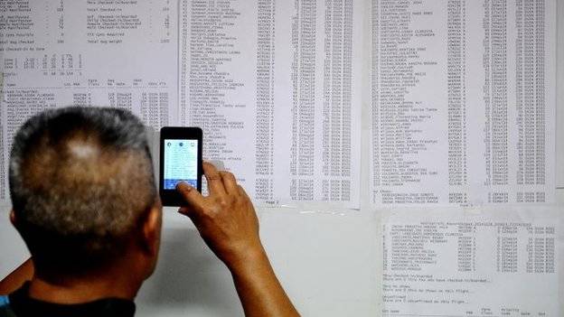 A relative checks to see if their loved one was on the plane.