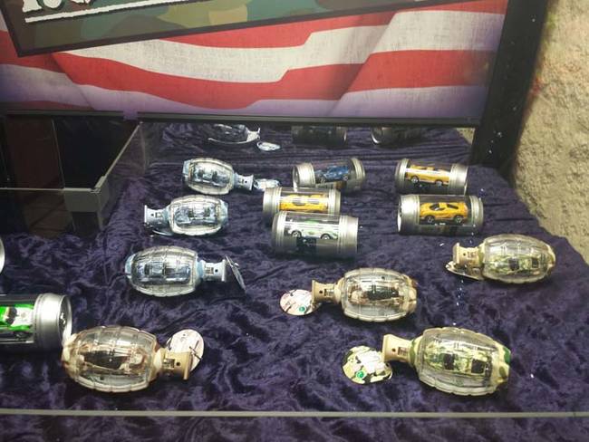 Selling cars encased in mini hand grenades and beer cans doesn't seem like the best idea.