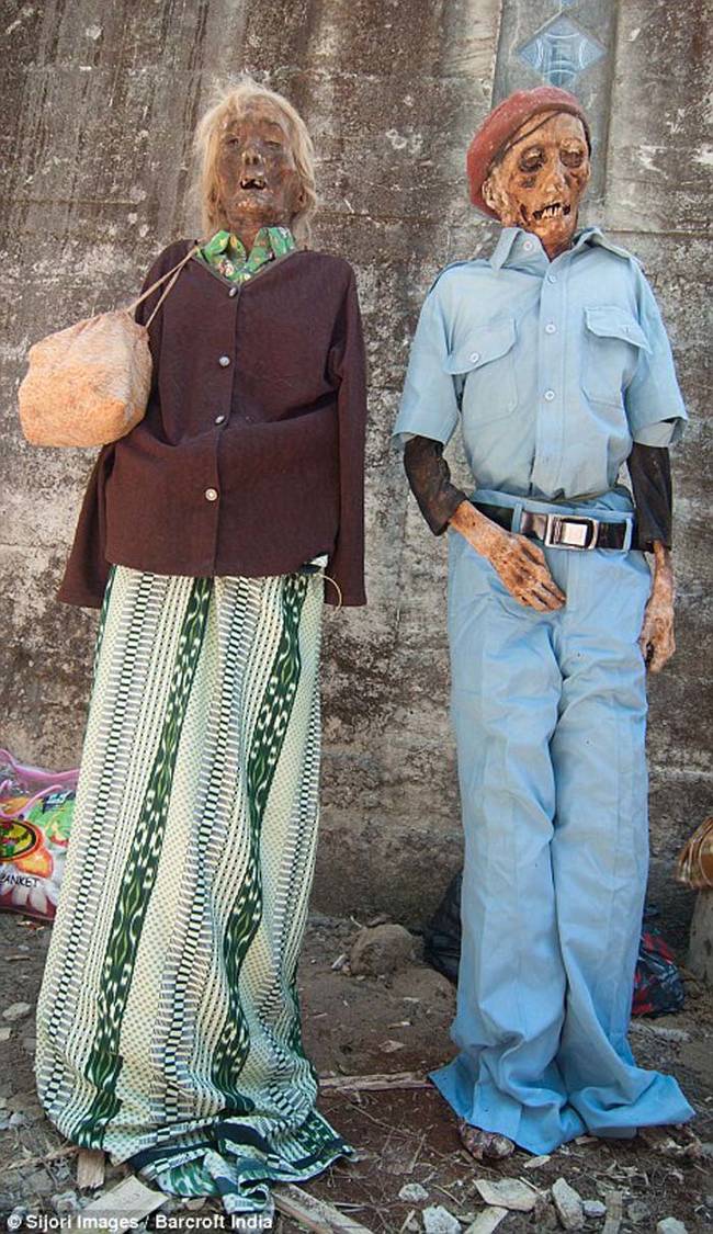 What makes this corpse cleaning ceremony possible is that the bodies are not buried in the ground. Rather they are placed in a cave or carved stone grave. This makes it easer for villagers to access the bodies of their loved ones when the time comes.