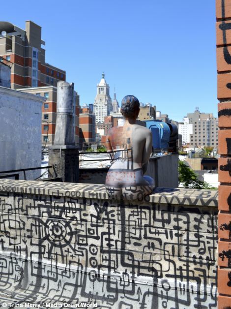 Sitting on a bridge with her back to the camera.