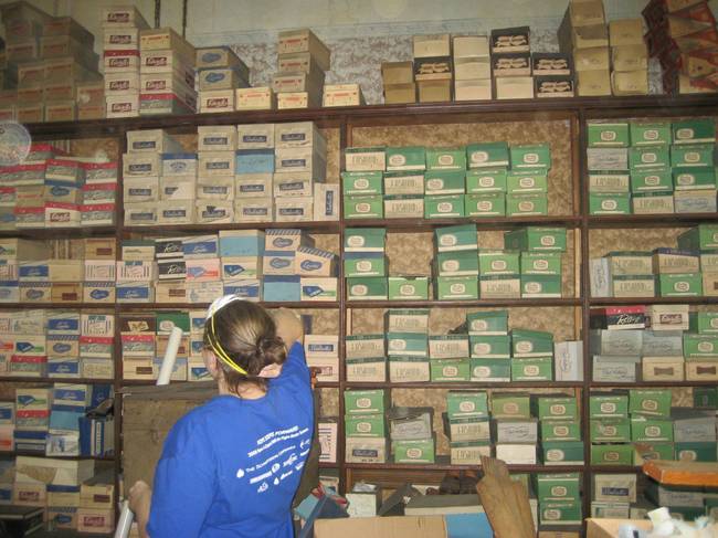 The family entered the old store and discovered a huge collection of old shoes.