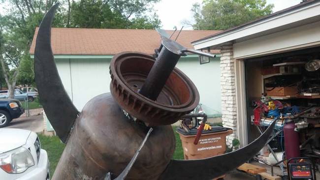 He used an old wheel as an "engine" and more scrap metal for "fins" to make the tank look like a rocket.