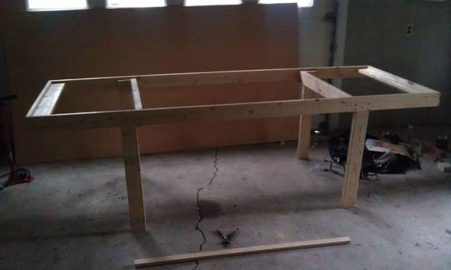 He started by making a frame for the table out of six 2x4 pieces of wood. The table is eight feet long and four feet wide.