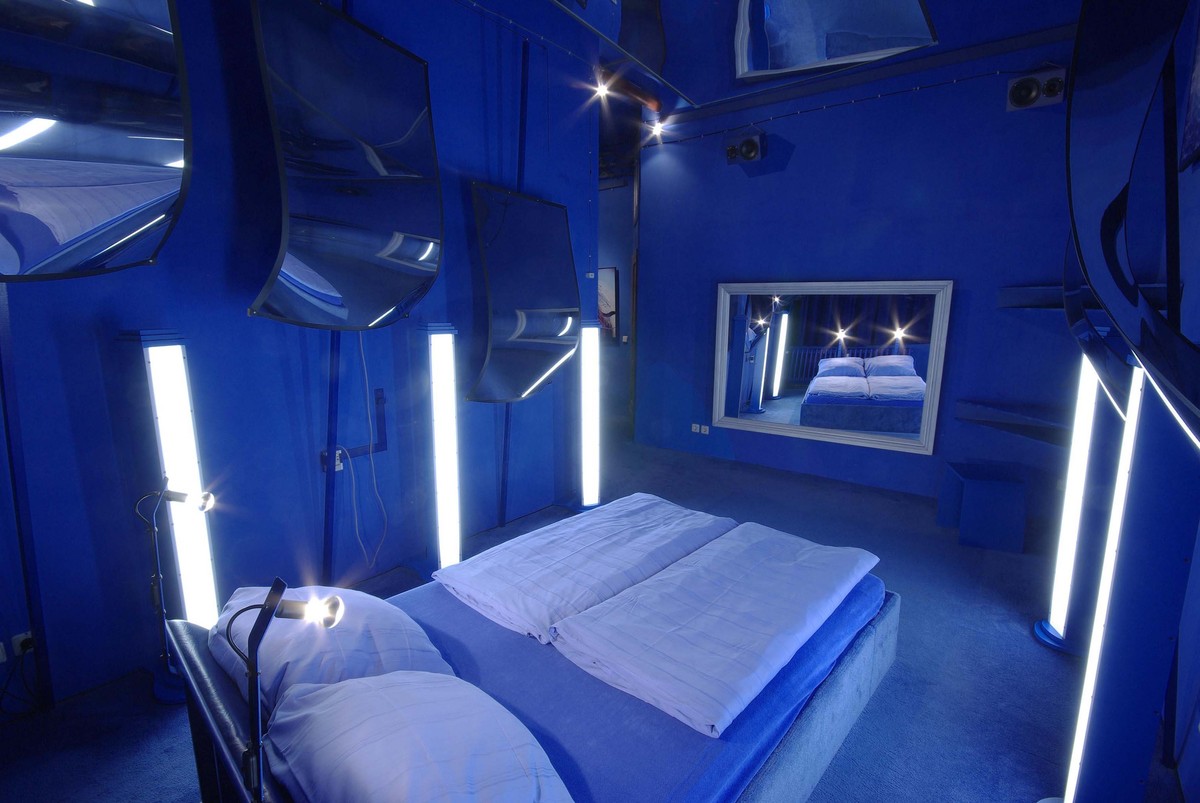 Old favourite: One of the original rooms, guests sleep in all-blue surroundings with no decor beyond glistening mirrors on the walls and ceiling .