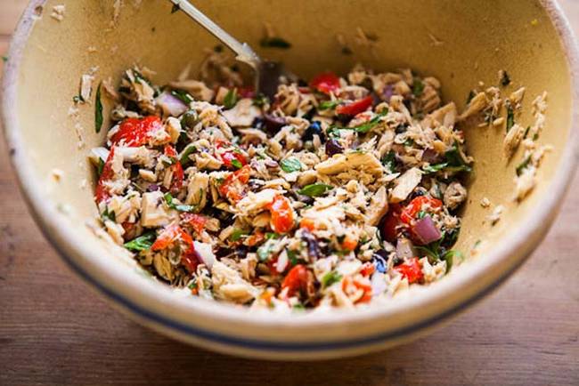 Mix flavorful veggies like peppers and olives in with canned tuna for a healthy, protein-filled meal. See the full recipe on <a href="https://blog.etsy.com/en/2013/eatsy-tuna-salad-with-peppadew-peppers-olives-and-herbs/">Etsy.