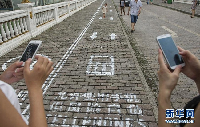 21.) In Chongqing, China, people addicted to their phones get their own lane to keep them safe while walking blindly around the city.