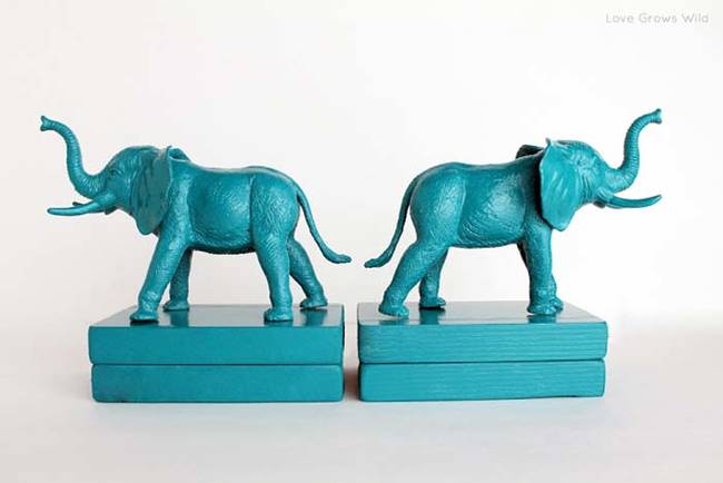 8.) Mount painted kids toys on to wood blocks to make <a href="https://lovegrowswild.com/2013/02/plastic-elephant-book-ends/" target="_blank">modern bookends</a>.