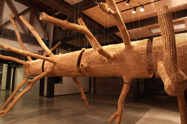 The sculpture is obviously a tree, but, horizontal and hollow, it becomes abstracted as well. 