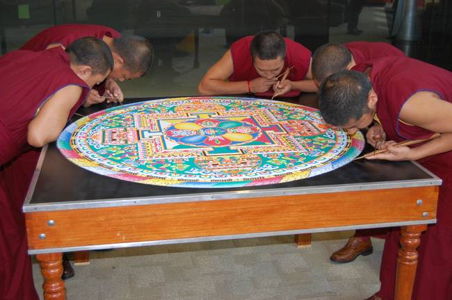 They start at the center of the Mandala and work their way to the edges.