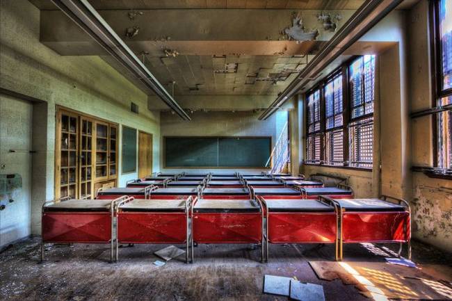 Despite the crumbling around them, the desks are still arranged very orderly.