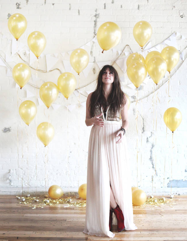 Balloons and white garland make a simple yet whimsical backdrop.