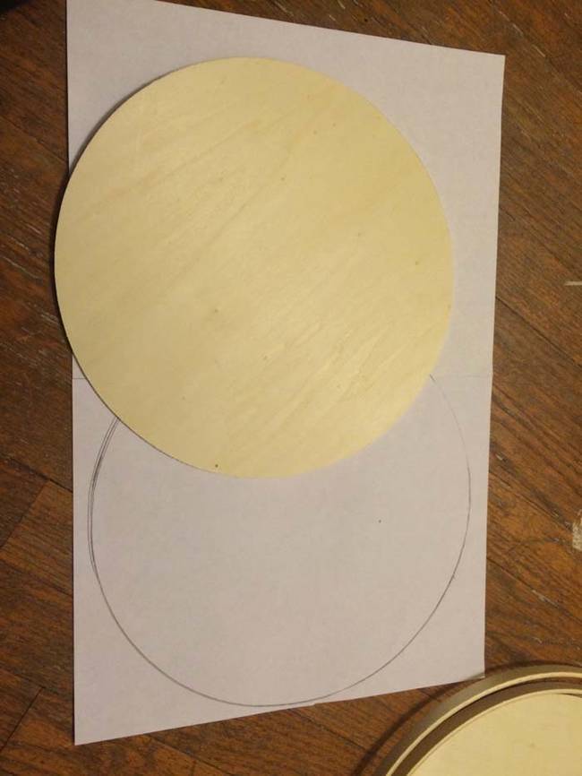 She started out by making a template for cutting her wood circles in half. She traced the circles on a piece of paper.