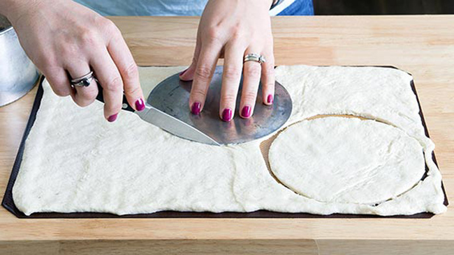 Unroll your pizza dough into one layer. Then cut out three 6-inch circles.