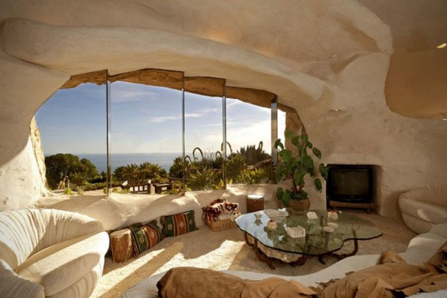 This Malibu home was once the summer residence of Dick Clark and his wife. The single story home has a cave-like interior, 22 acres of land, and great views of the ocean. Bottomless car not included.