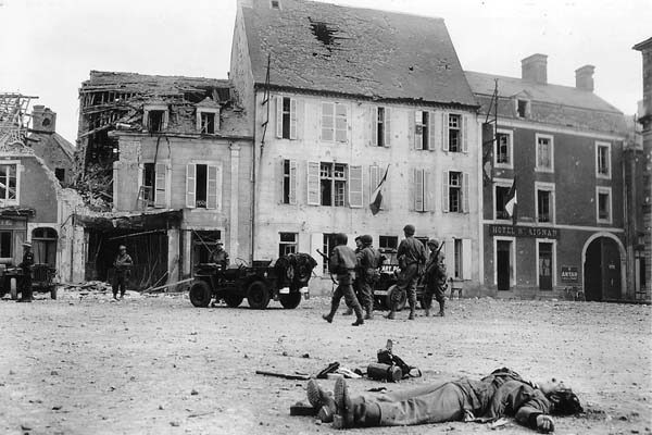 A slain German soldier lies in the main square of Place Du Marche in Trevieres.