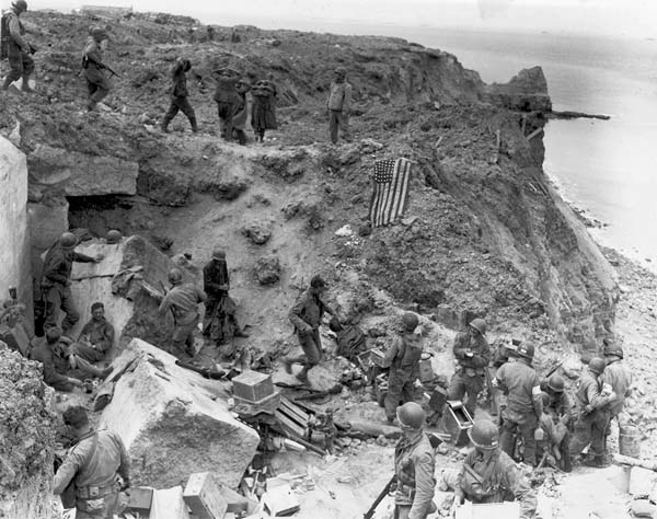 A US flag lies as a marker on a destroyed bunker.