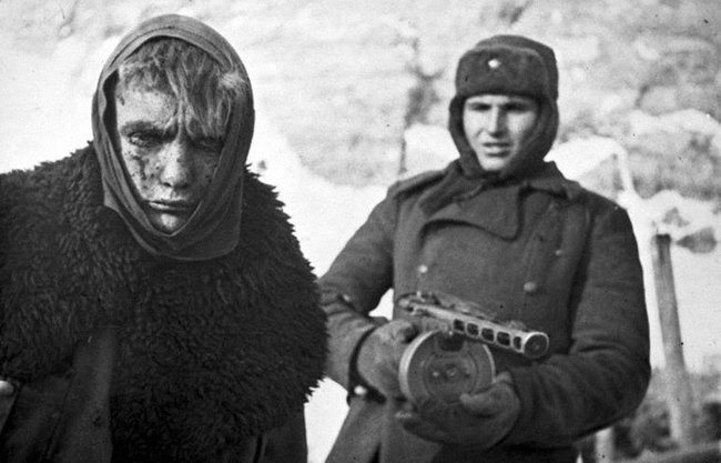 7. Defeat - Red Army soldier marches a German soldier into captivity after the Battle of Stalingrad.