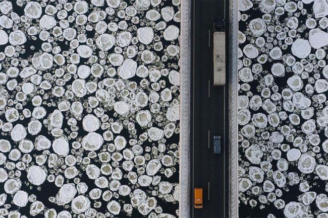 28.) An aerial view of a bridge over icy water.