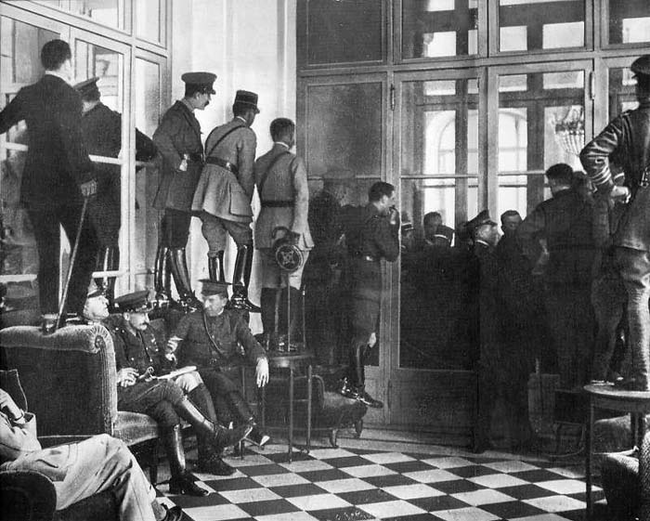 14.) 1919 - Spectators watch the signing of the Treaty of Versailles.