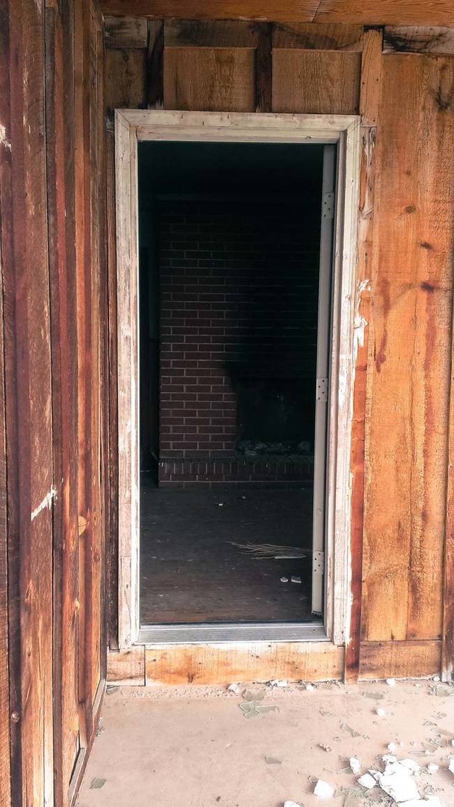 Looking in from the broken front door. What's strange is that despite it being clearly abandoned, the house has suffered no major vandalism.