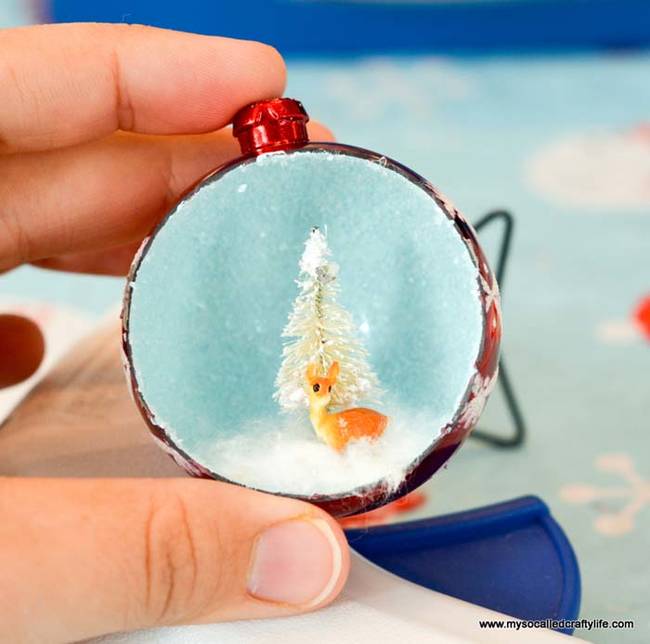 Pull apart your cotton balls for snow. Put a little bit of glue on the ornament floor, and use a toothpick to push it down.